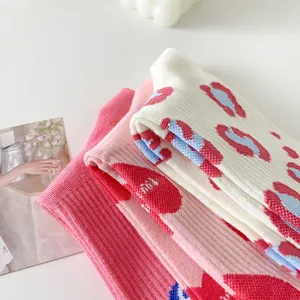 Sweet pink mid-tube socks with cute heart patterns, perfect for daily wear and spring autumn fashion.