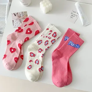 Close-up of cute mid-tube women's socks with heart, leopard, and letter prints.