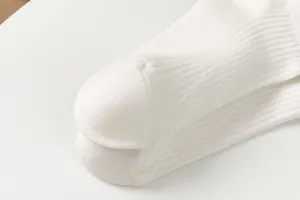 Close up detail of white ribbed women socks showing heel texture and clean knit fabric style.