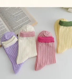 Breathable mesh mid-tube stack socks detail view showing delicate texture and contrast cuffs.