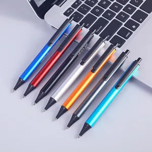Close-up of colorful metal gel pens set, neatly arranged on laptop keyboard for office supply.
