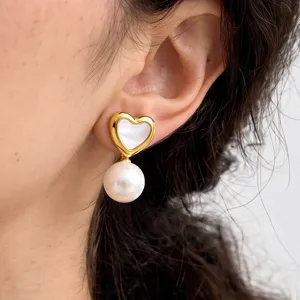 Close-up detail of vintage heart pearl drop earrings, elegant daily wear jewelry piece.