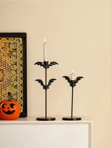 Vue détaillée de bougeoirs en fer motif chauve-souris pour Halloween sur table, jolie déco.