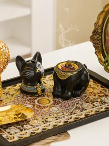 Detailed view of Egyptian cat incense burner, black and gold resin home decor for aromatherapy.