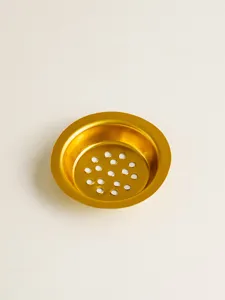 Golden metal censer gasket detail, hollowed-out hardware accessory for incense burners.