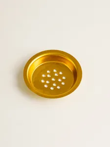 Gold metallic incense burner mesh gasket detail, hollow ventilation hardware accessory.