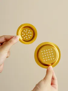 Gold perforated metal disc accessory for incense burner and metal craft display detail