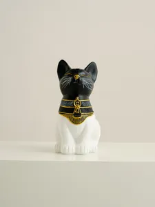 Detailed shot of an Egyptian cat incense burner, black and white design with gold details.