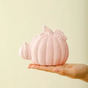 Pink ceramic pumpkin decor, modern cute desktop ornament for home office autumn harvest.