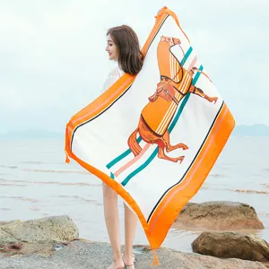 Elegant square silk scarf featuring a chic equestrian motif, perfect as a stylish beach wrap.