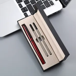 Detail shot of business metal pen set with red pen and refills in black gift box.