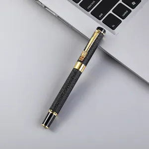 Luxury metal business signature pen with black textured barrel and gold dragon clip detail.