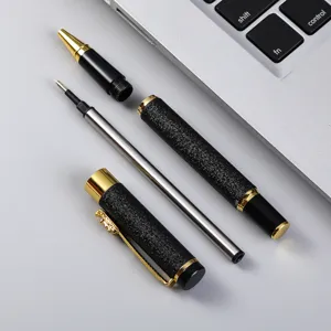 Detailed view of luxury black metal rollerball pen with gold trim and textured finish, close-up.