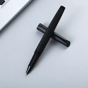 Detail shot of the black engraved metal rollerball pen showing fine spiral texture surface.