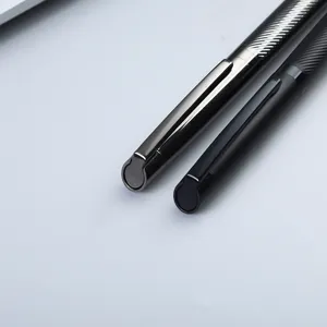 Close-up view of luxury engraved metal signature pens showcasing exquisite grip texture and sleek design.