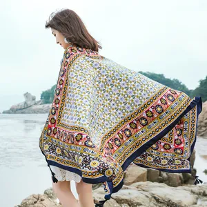 Detailed close-up view of bohemian style printed beach shawl scarf with tassel outdoors.