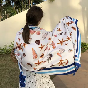 Oversized beach towel scarf with seashell print and striped border for women sunscreen shawl.