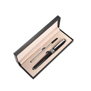 Close-up detail of luxury metal signature pen set with black gift box and beige velvet lining.