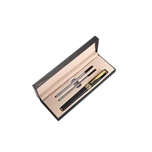 Close-up detail of luxury metal ballpoint pen set with two refills in black gift box.