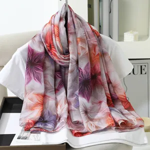 Detail view of a large faux silk floral print scarf, elegant garden design, soft texture.