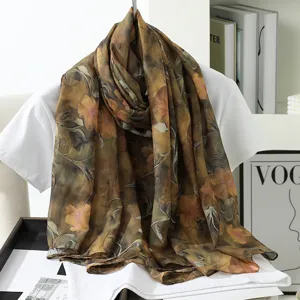 Detailed view of large vintage floral silk scarf in brown, elegant accessory for women.