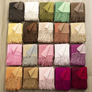Detailed view of winter double-sided cashmere-feel scarves showing neat fringes and rich colors.