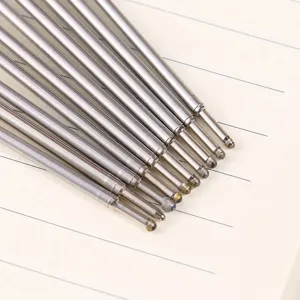 Detailed close-up of metal ballpoint pen refills with fine bullet tips for smooth writing.