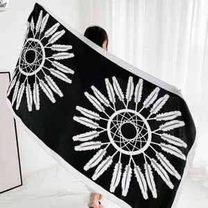 Close-up detail of the black and white ethnic feather pattern shawl and decorative scarf.