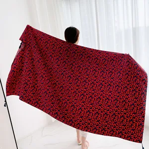 Detailed view of vintage ethnic style red floral printed women shawl with tassel trim.