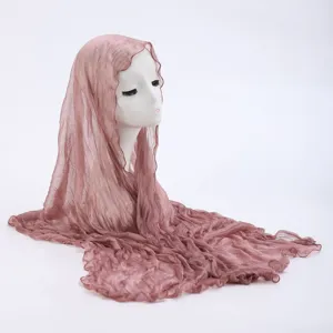 Detail view of pink crinkled hijab scarf showing lightweight fabric and texture.