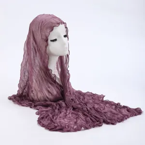 Detailed view of women's purple crinkled hijab scarf, lightweight summer sun protection shawl.