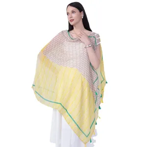 Women ethnic style patterned shawl cape with tassels and green border for travel photography.