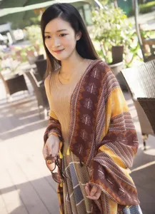 Ethnic style fringe scarf detail shot, brown yellow geometric pattern cotton linen wrap.