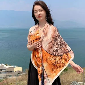 Detailed view of the large floral square scarf worn outdoors, featuring a vibrant floral design.