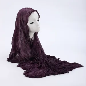Close-up detail view of the dark purple crinkled hijab scarf showing fine fabric texture.