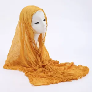 Detailed view of the yellow crinkled lightweight scarf showing soft texture and fine pleats design.