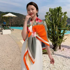 Detailed close-up view of women's colorful floral chain square scarf versatile resort shawl.