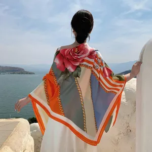 Detail shot of women large floral scarf with chic chain print, elegant outdoor scenic view.