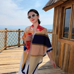 Elegant floral and chain print square scarf, stylish shawl worn outdoors by a model.