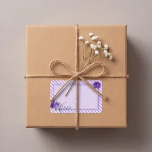 Detail view of kraft paper gift box with twine, baby's breath, and purple floral blank label sticker.