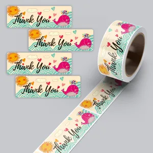 Detailed view of rectangular thank you stickers roll, cute whale design, coated paper label for gifts.