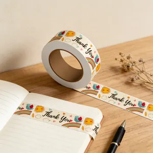 Detail view of cute rectangular thank you stickers roll featuring sun and bird patterns on a book.
