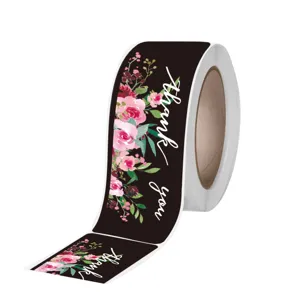 Roll of black watercolor floral thank you stickers for packaging seal and order appreciation.