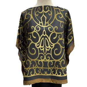 Detailed shot of the black and gold baroque print top showing intricate ornate gold patterns.