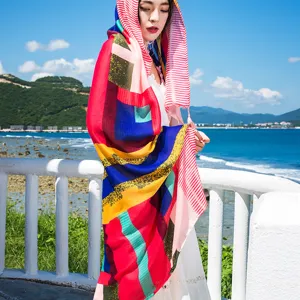 Vibrant ethnic geometric scarf detail shot, perfect seaside beach shawl and summer sun protection.
