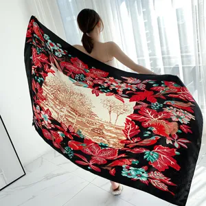 Detail of vintage style silk scarf with nature landscape print and floral border, elegant shawl.