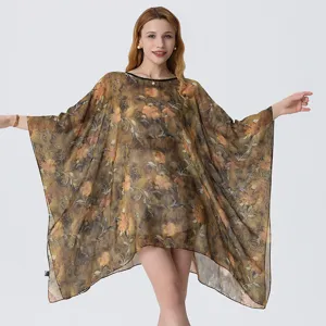Detailed view of the vintage floral print chiffon beach cover-up with loose draped sleeves.
