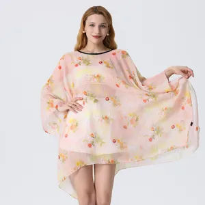 Detailed view of women's floral print chiffon beach cover-up, loose casual summer resort dress.