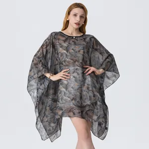 Detailed view of women's summer 3D printed sheer georgette beach poncho dress fabric texture.
