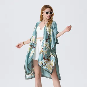 Light blue floral print kimono cover-up detail, elegant sheer beach shawl with split design.